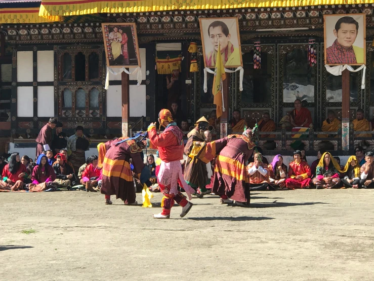 a group of people in traditional dress performing tricks