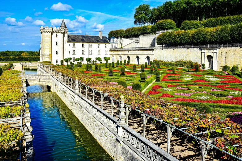 the building is situated at the foot of a walkway in the middle of the garden