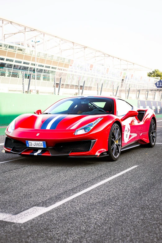 a red sports car is parked on the track