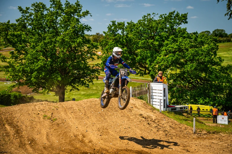 a person jumping on the dirt bike over some rocks