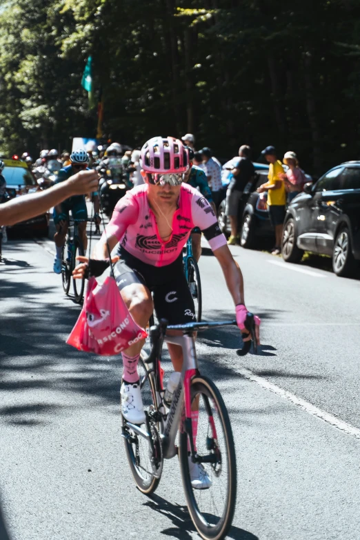 the young lady is wearing a pink helmet and is riding her bike