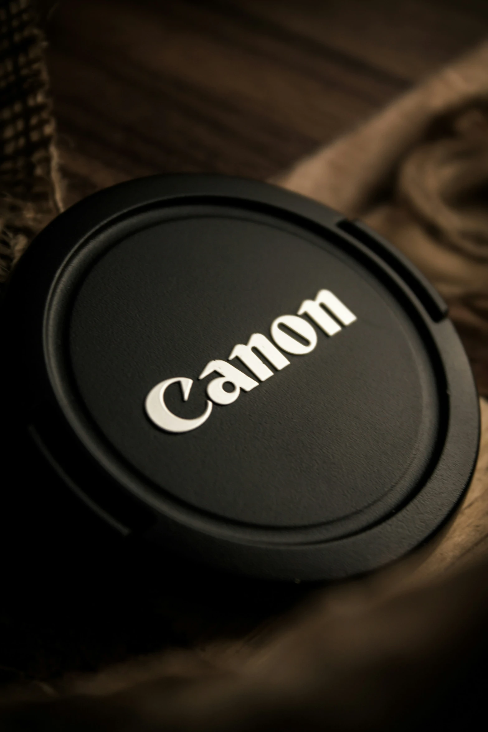 black camera lens cap sitting on a table