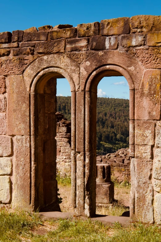 the ruins of a large building with two archways