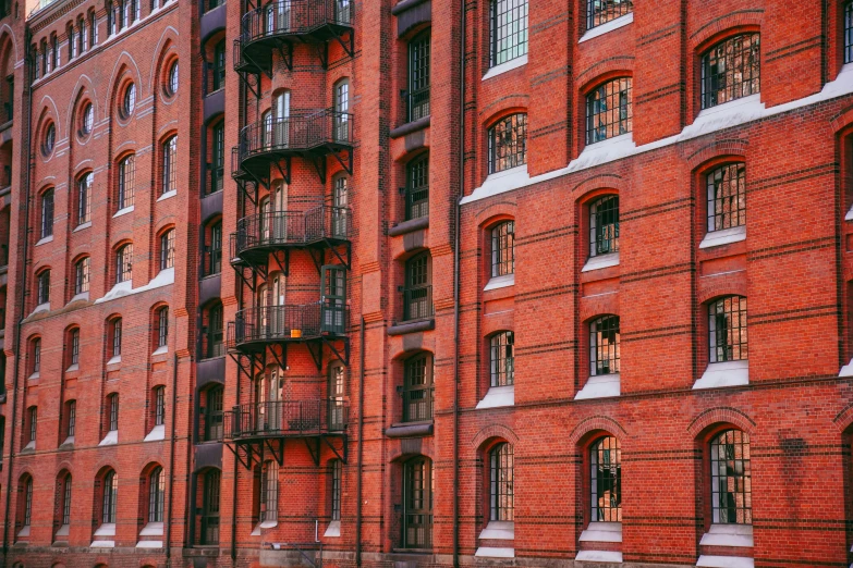 a very tall red brick building with some windows