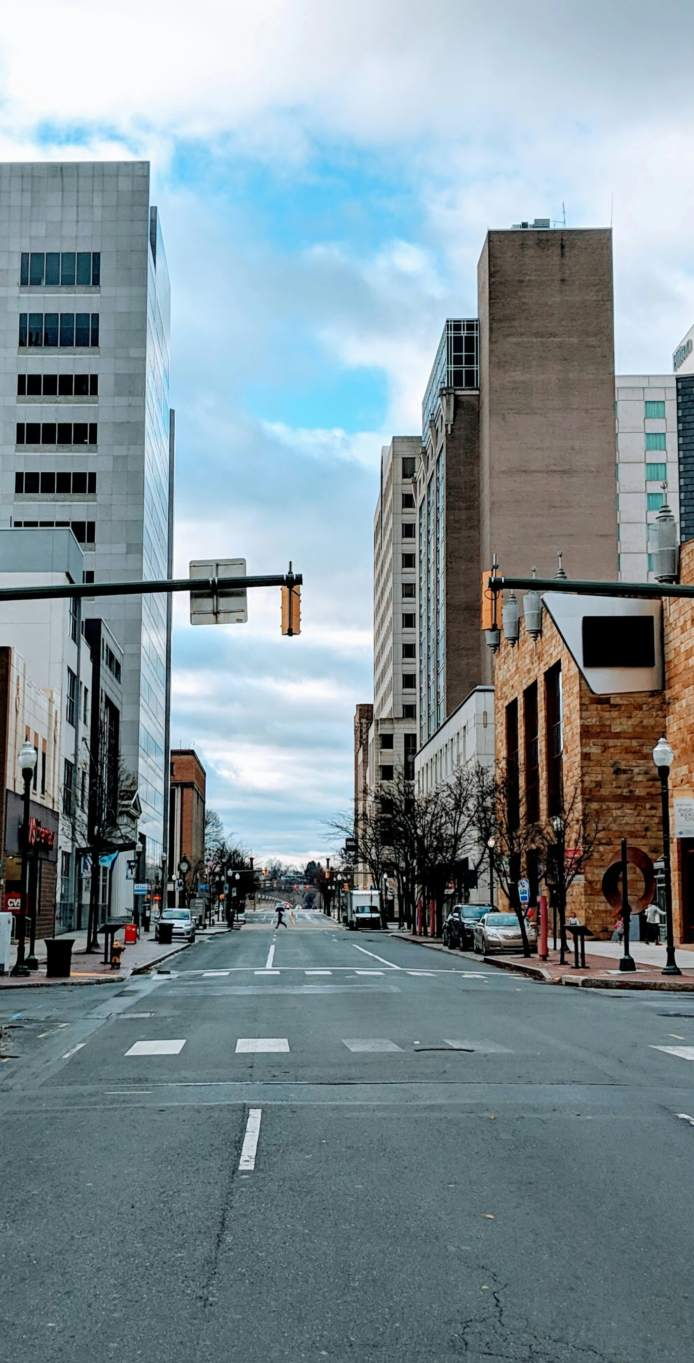 an empty city street with a yellow traffic light