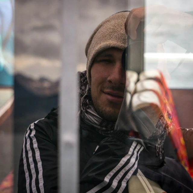 a man in striped hoodie on public transportation