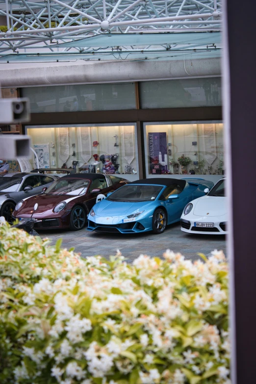 several super cars are parked in a parking lot