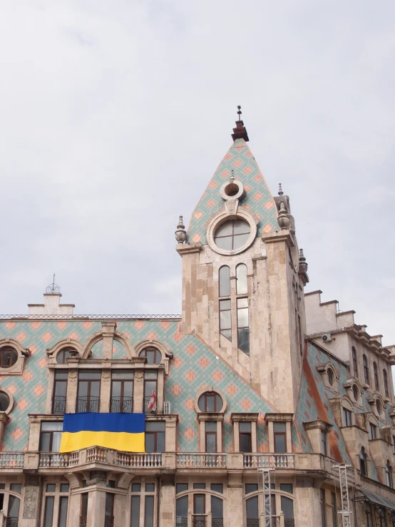 the large building has several windows and a flag