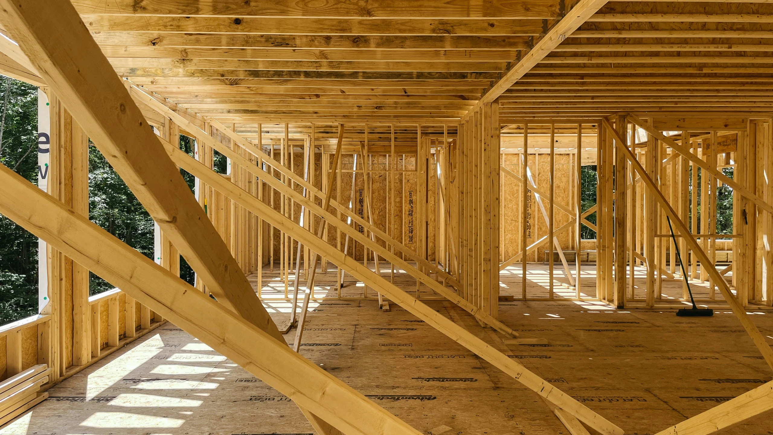 the floor of a home under construction with lots of wood framing