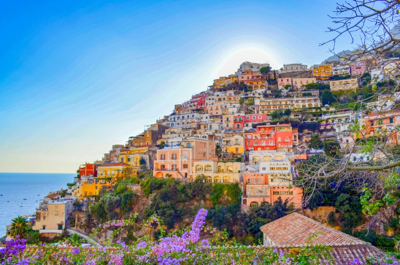 a hill that is covered in houses with flowers around it