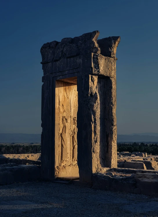 an old doorway with paintings on it near a stone structure