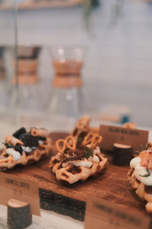 small pizzas sit on wooden boards in a bakery