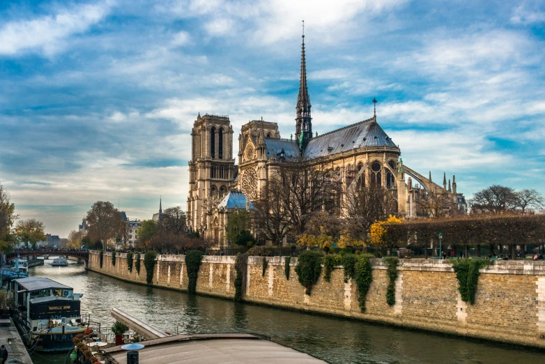 a river and bridge next to an old cathedral