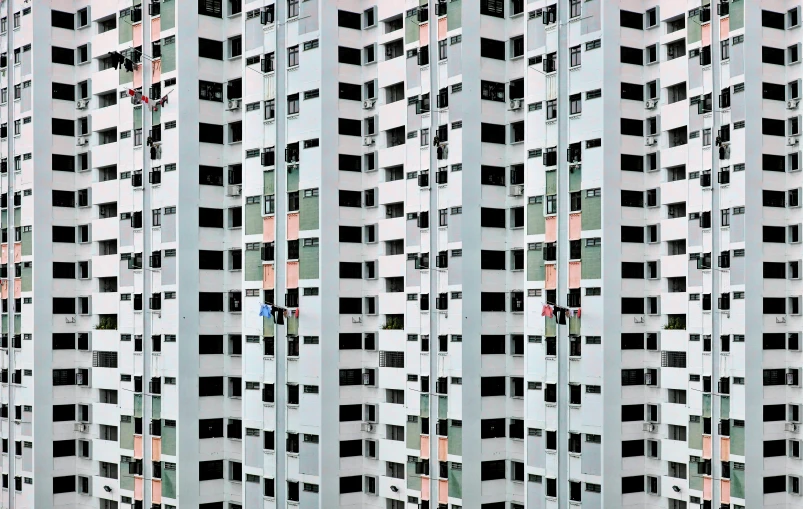 a grey tall building with lots of windows