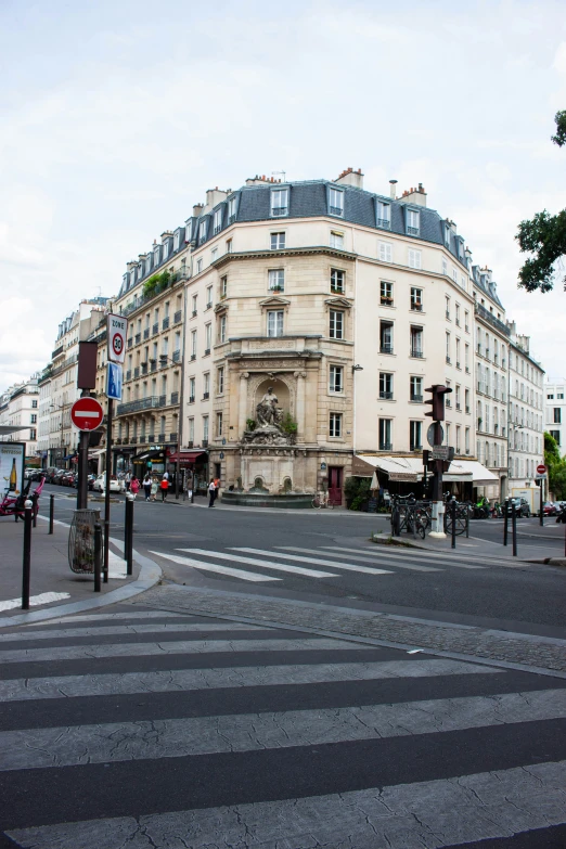 the corner of a street with buildings in the background