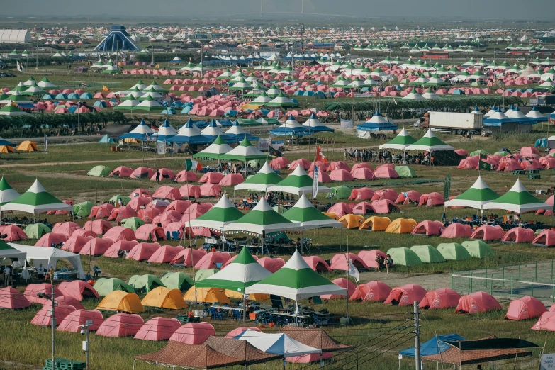 the large field is covered in many colorful tents