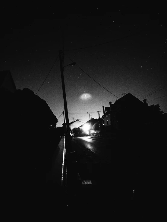 a street at night with traffic lights glowing on the dark background