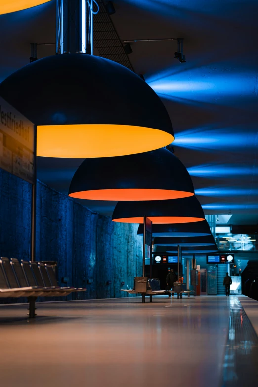 an empty bus station has many hanging lights