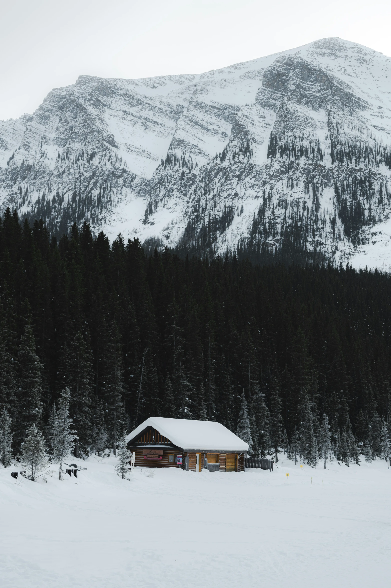 a mountain view with a cabin sitting in the snow