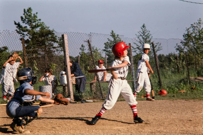 a young baseball player swings for a pitch