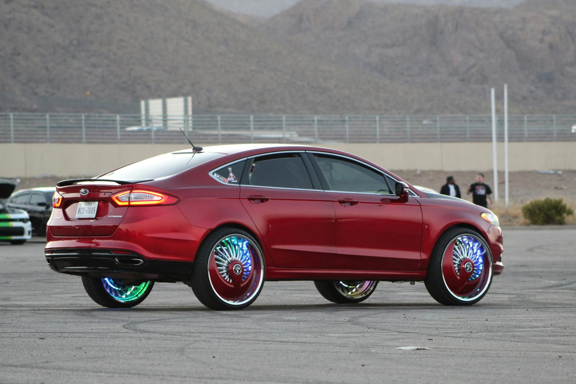 the car is red and features chrome rims