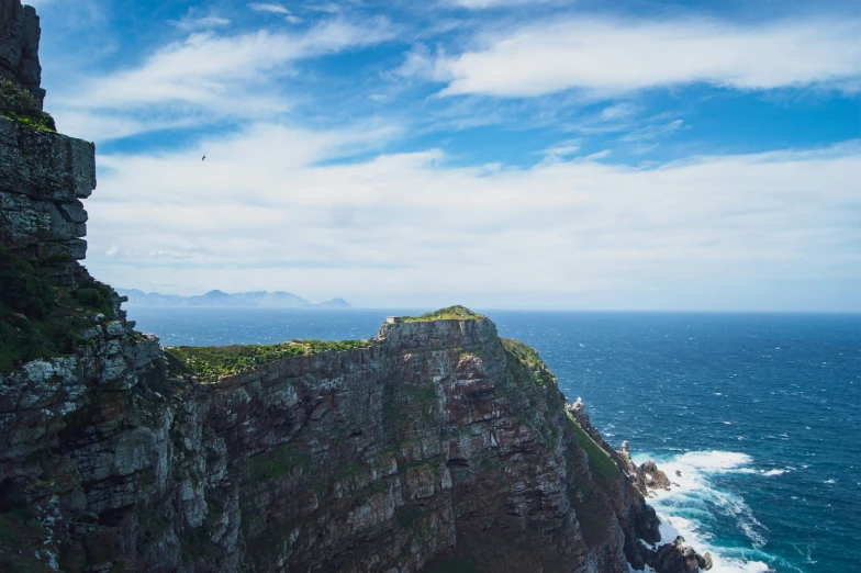 cliff overlooking sea with a cliff tower in the middle