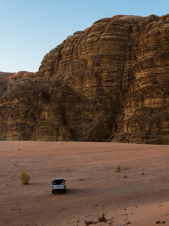 an outback pickup truck on a desert road in the daytime