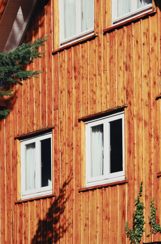 there is a brown building that has three windows