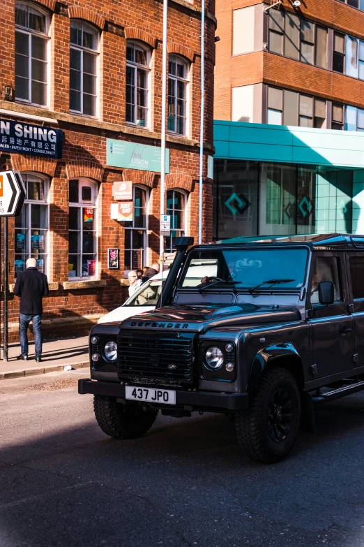 a black suv parked in front of an old brick building