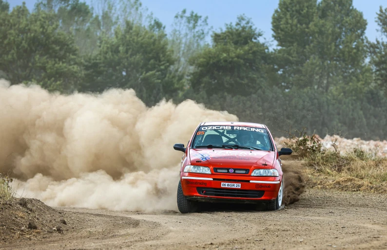 a rally car driving down a dirt road