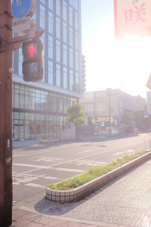 a street light is on at the corner of a city street