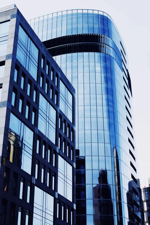 the reflection of two buildings in the glass