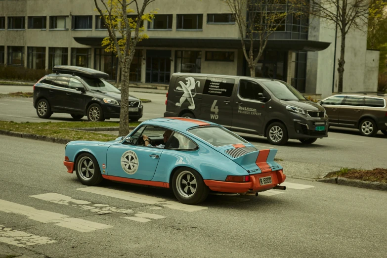 blue and orange race car parked in parking lot