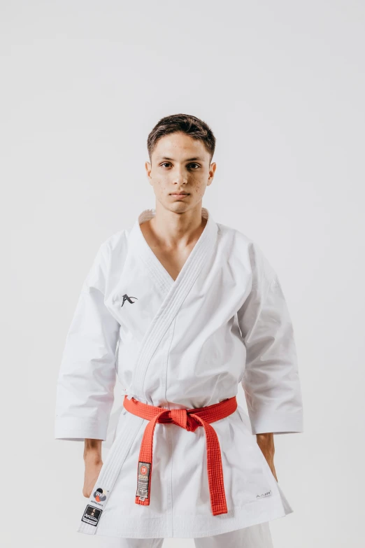 a person wearing a karate outfit with one hand