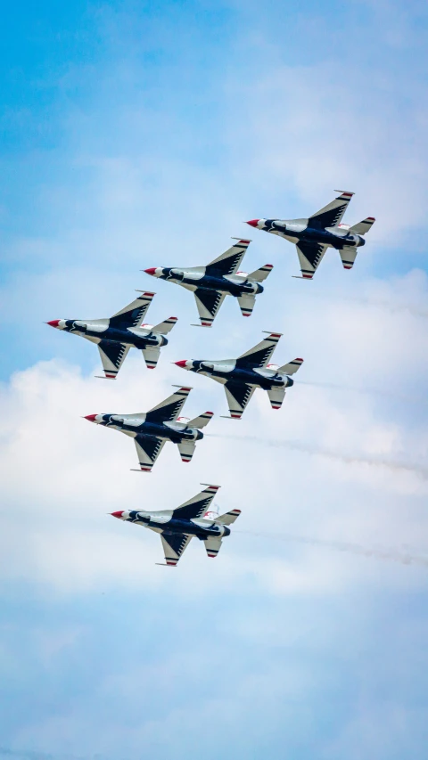 a formation of fighter jets flying in the sky