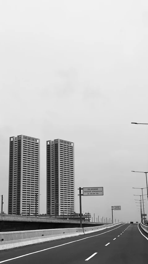 a black and white po of the street sign and traffic lights on the side