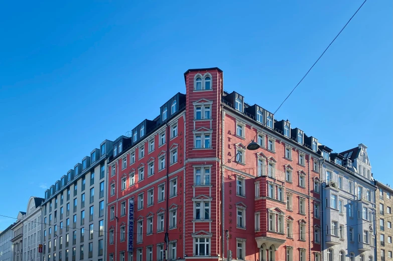 a red brick building sits behind many grey and yellow buildings