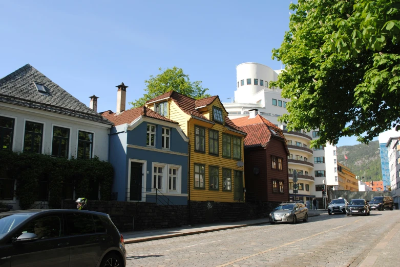 many cars are parked on a small street