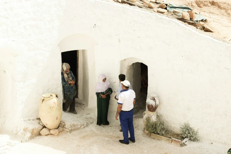 two people who are standing near two doorways