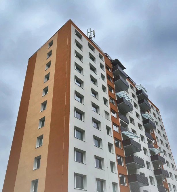 a tall white and brown building with a clock at the top of it