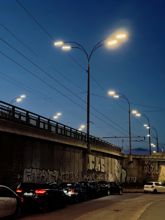 cars parked at an intersection in a town under traffic lights