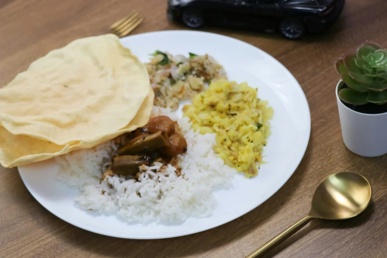 a white plate topped with rice and meat