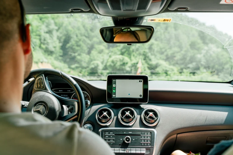 a person with an ipad sitting in a vehicle