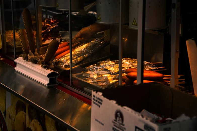 several food items being cooked on grills in a store