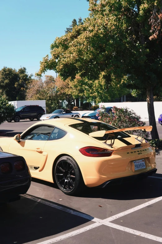 a sports car in a parking space with the trunk on the top of the back