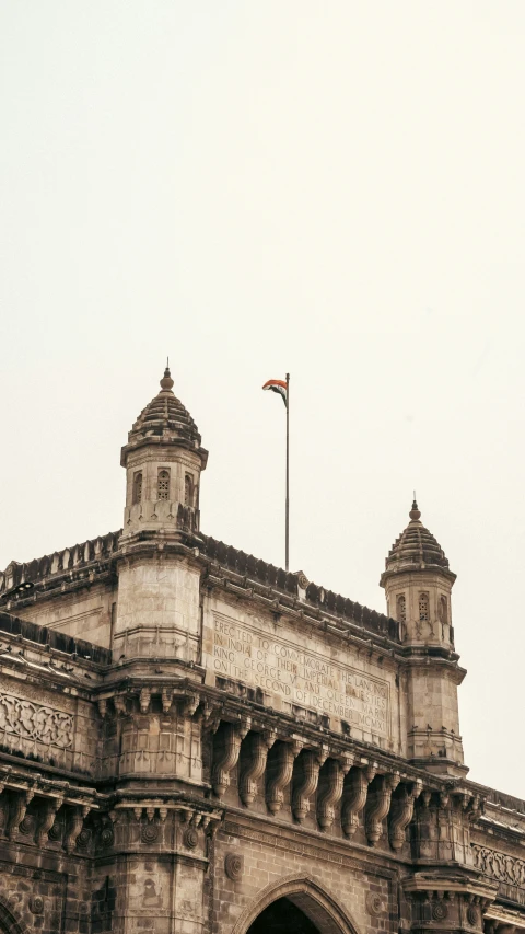 a large grey building with two towers