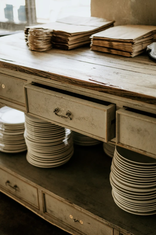 stacked plates are on the side table and placed on top