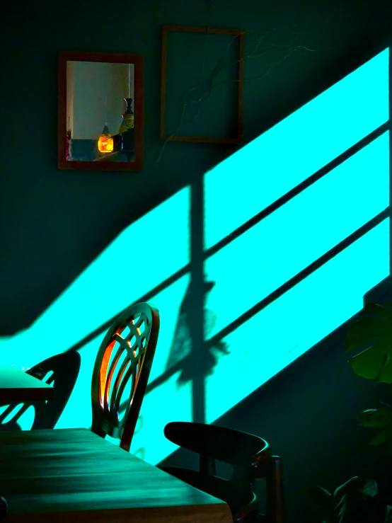 the wall of a dining room is lit up with green light