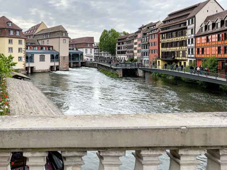 a view of a river with houses on both sides and bridge on each side