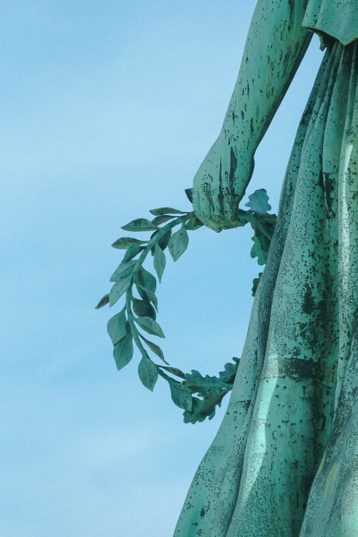 a statue with many vines hanging off the side